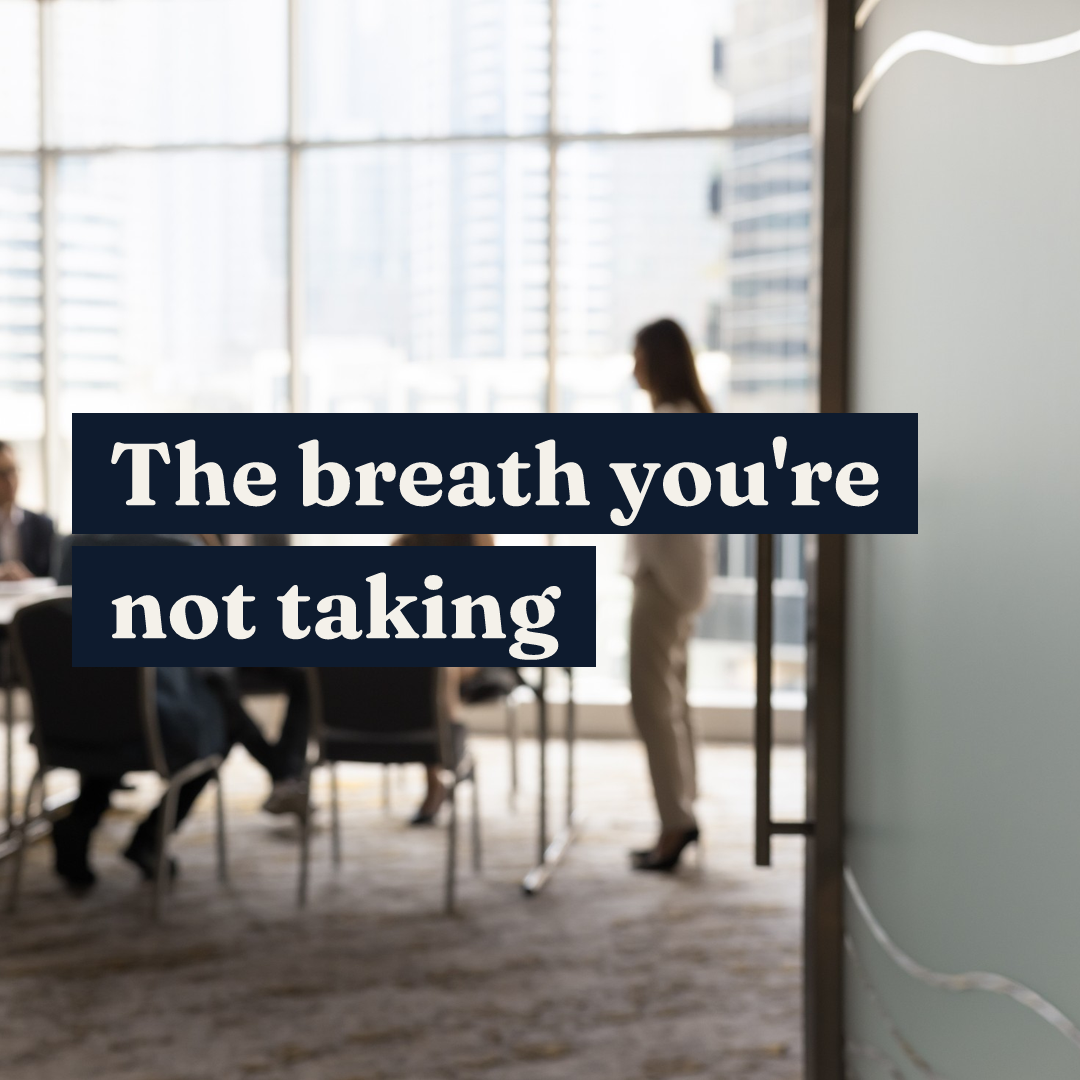 The breath you're not taking text over a blurred office meeting room with a city view.