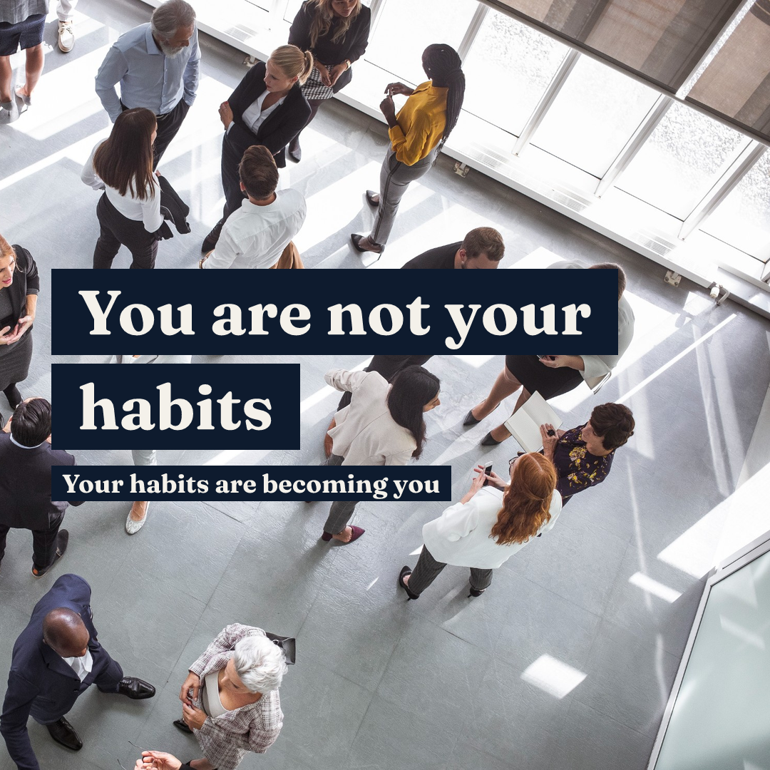 Professionals networking in a bright office with the text 'You are not your habits. Your habits are becoming you.'